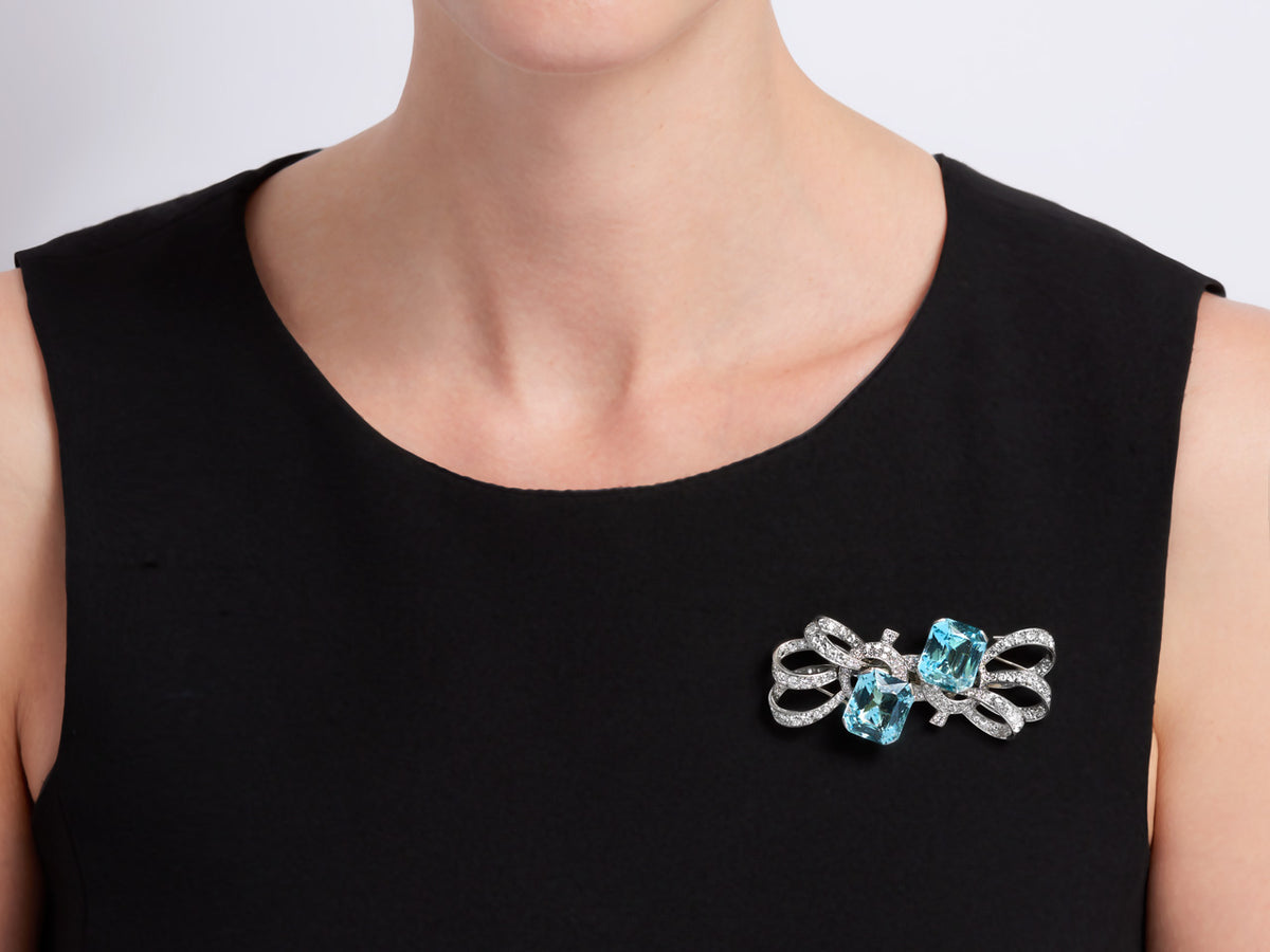 Aquamarine and diamond double clip brooch on a black dress