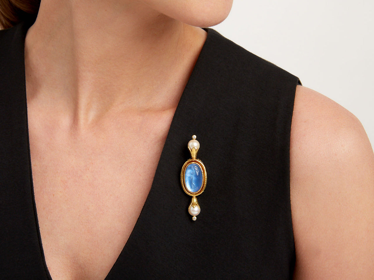 Gold brooch with blue glass intaglio and pearl accents