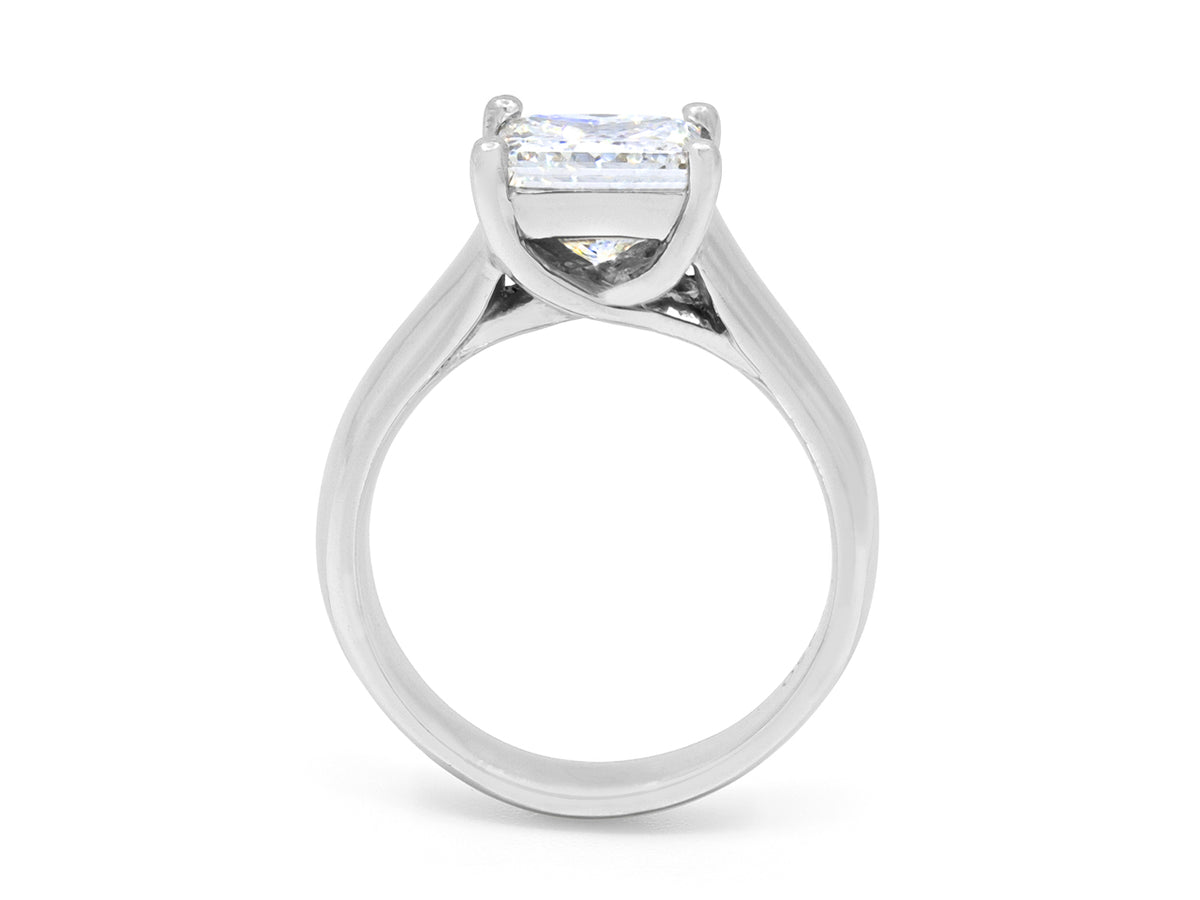 Side view of platinum solitaire ring with princess cut diamond