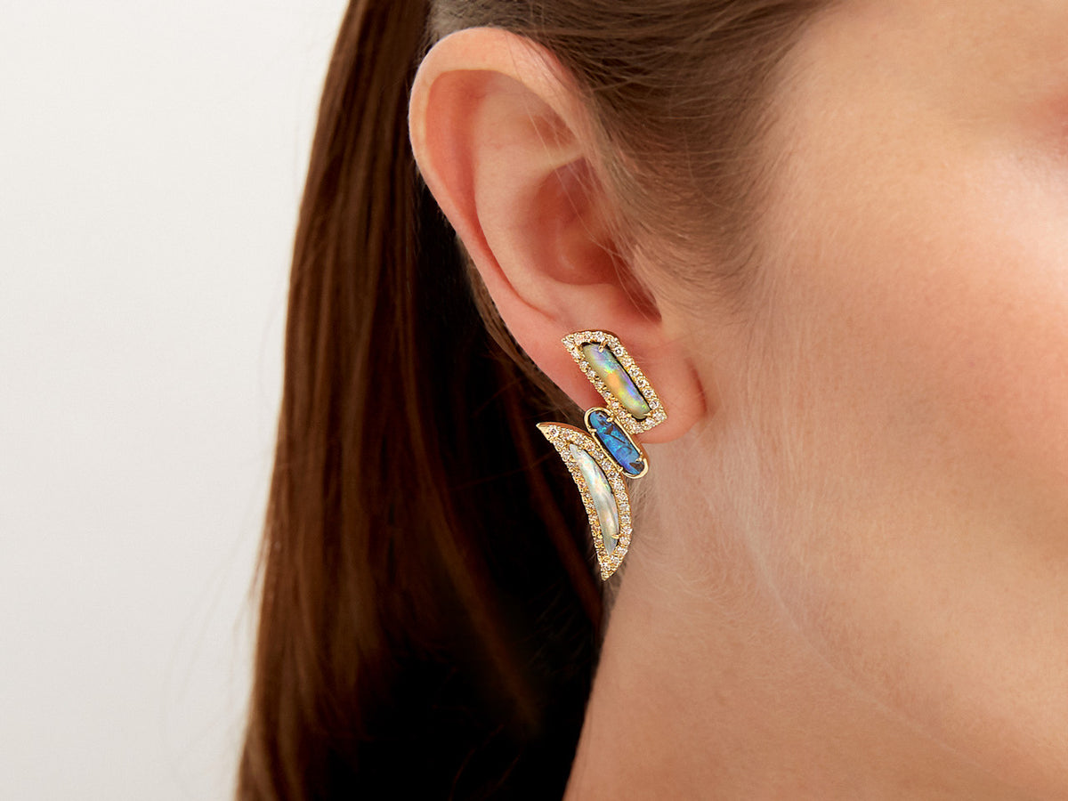 Close-up of a blue opal and diamond gold earring