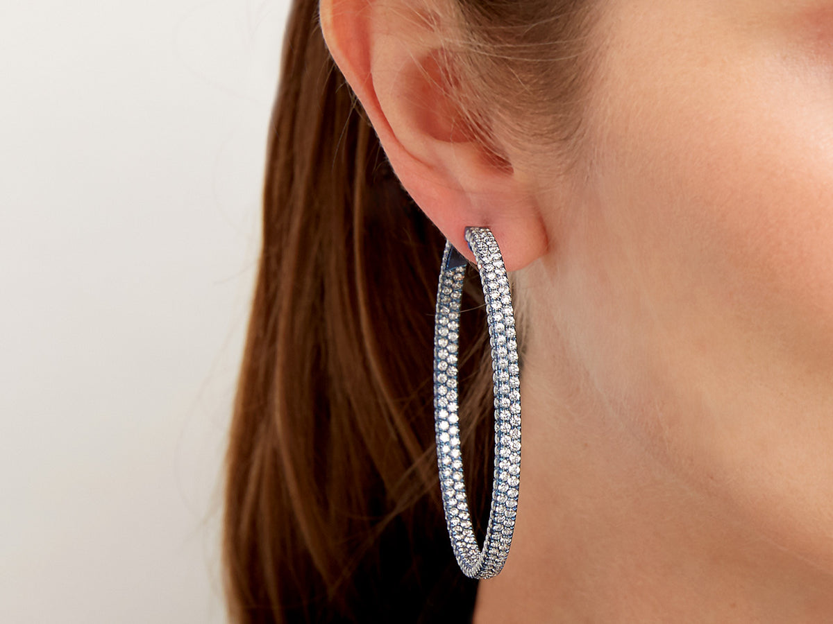 Pavé diamond hoop earring worn on ear