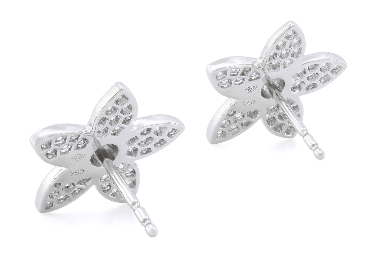 Back view of two white gold flower earrings
