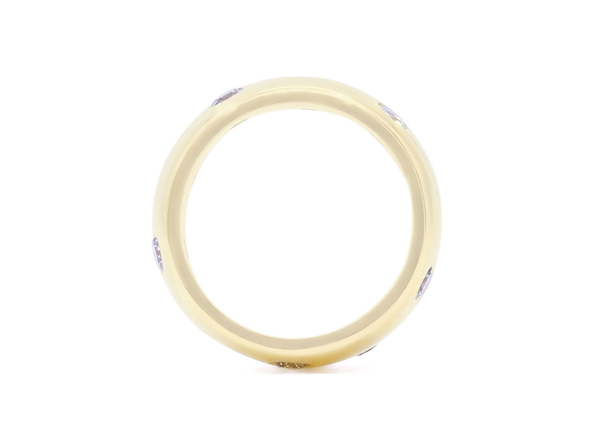 Top view of a wide 18k gold diamond band