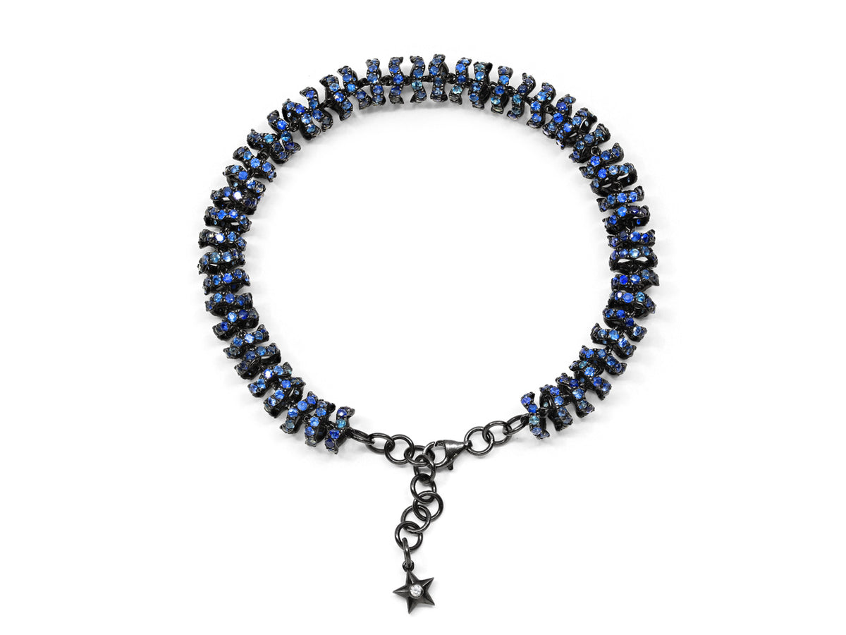 Blackened gold bracelet with blue sapphires and star charm