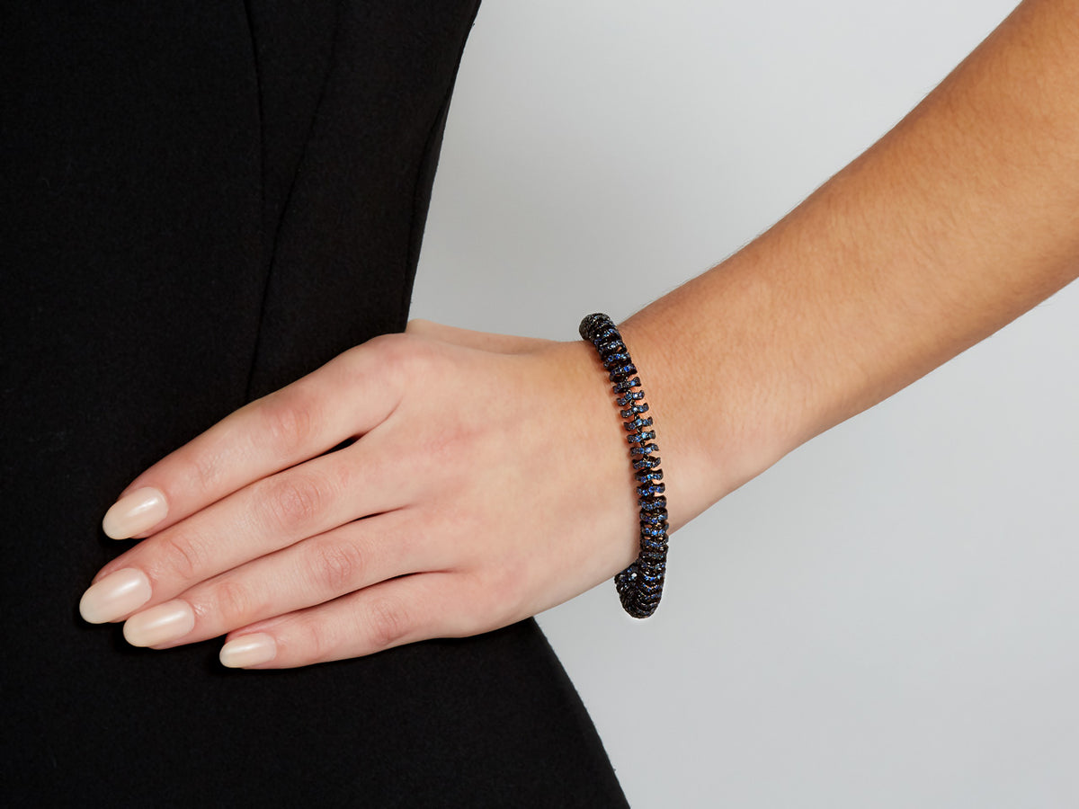 Sapphire bracelet in blackened gold worn on wrist