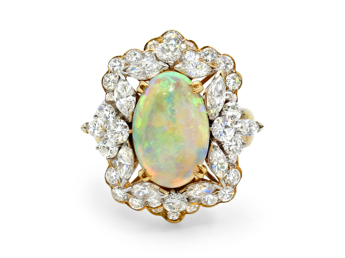 Oval white opal and diamond halo ring in 18K gold