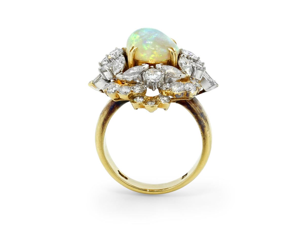 Side view of white opal and diamond halo ring in 18K gold