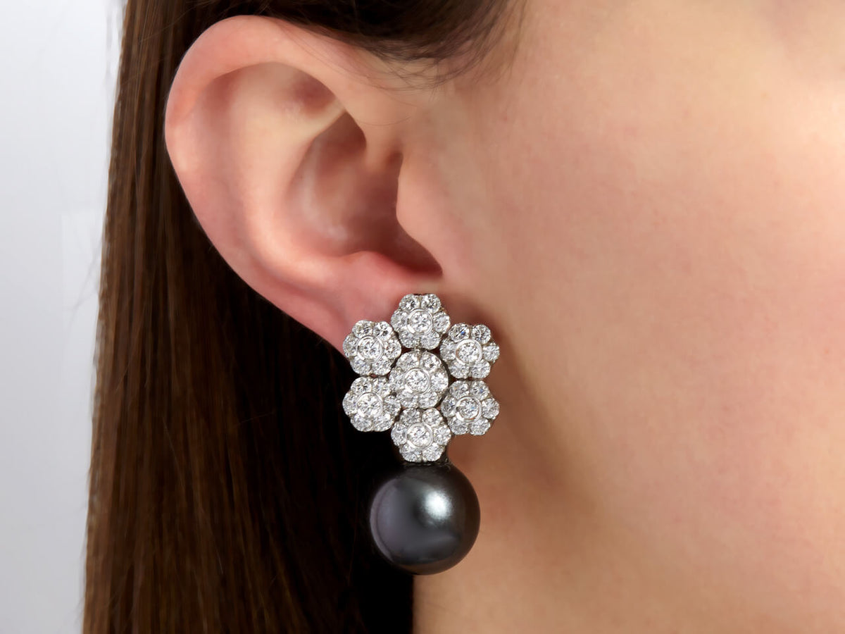 Diamond flower earring with dangling black pearl