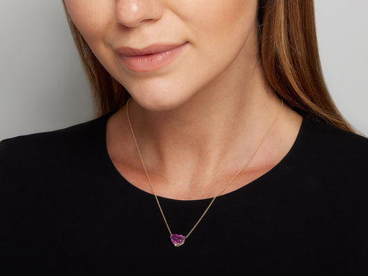 Heart shaped pink sapphire pendant on an 18K gold chain
