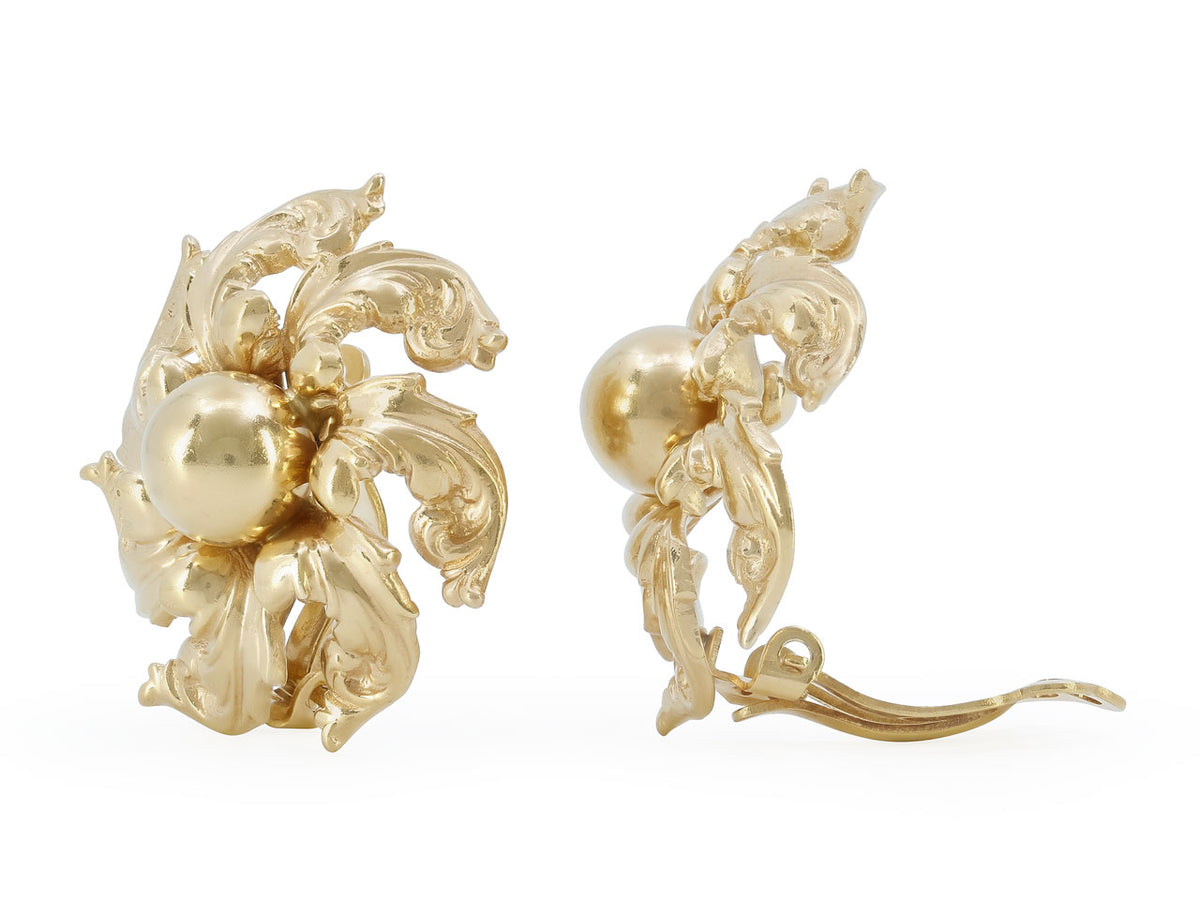 Pair of 14K gold earrings with domed centers and foliate swirls