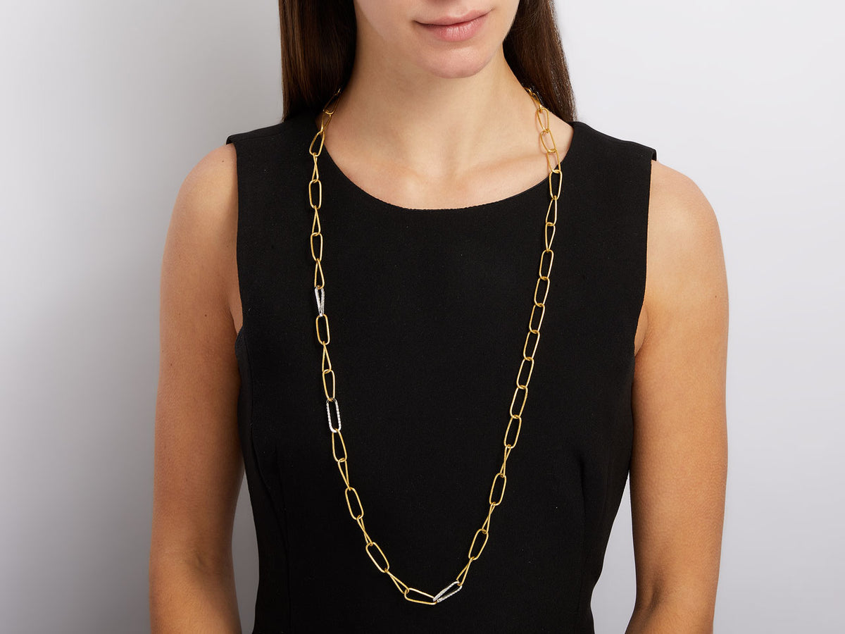 Gold link necklace with white gold accents on model