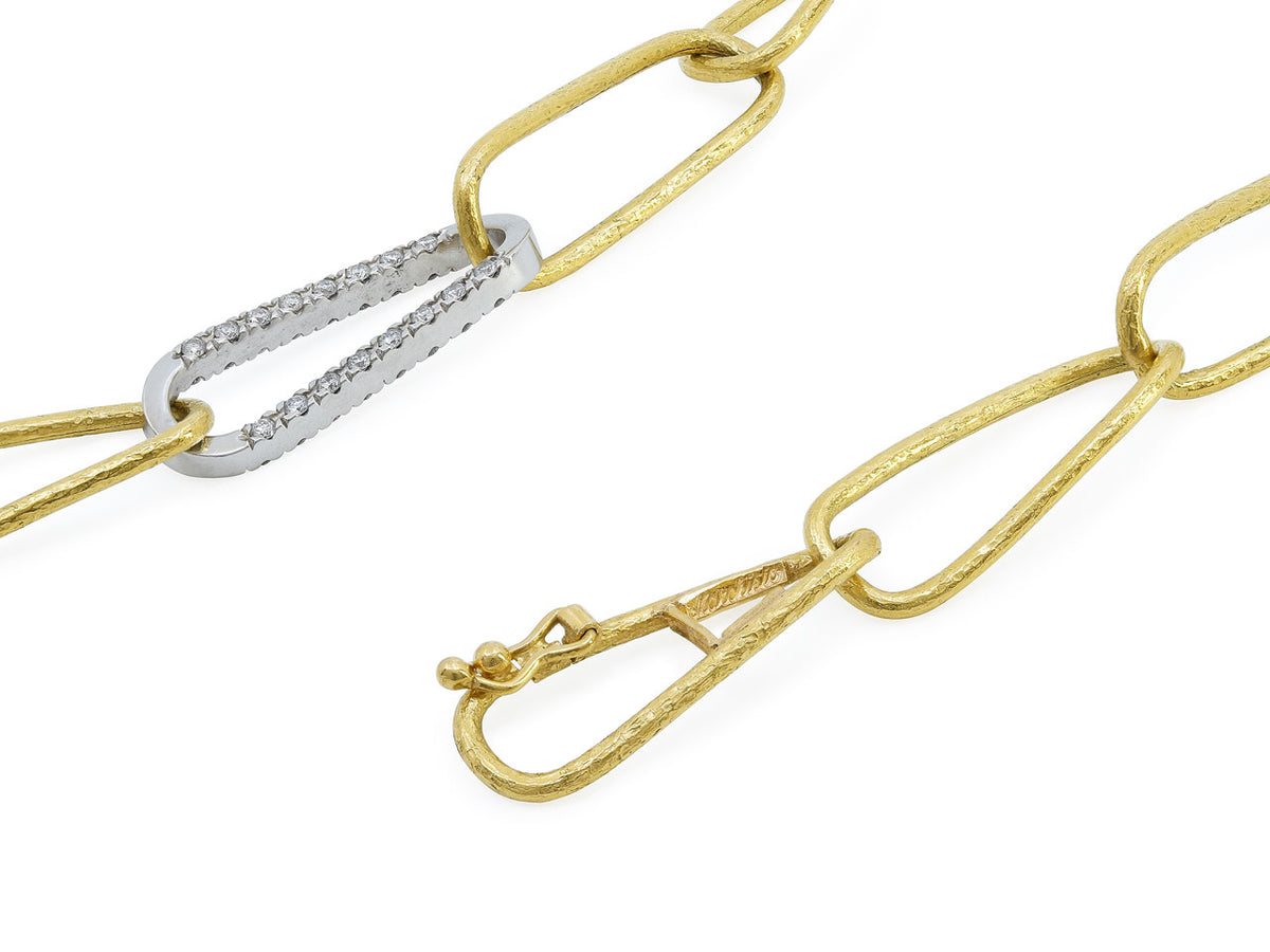 Close up of textured 18k gold paper clip necklace with diamond set white gold links and clasp