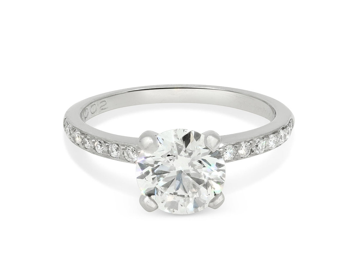 Platinum pave diamond solitaire ring with round center stone