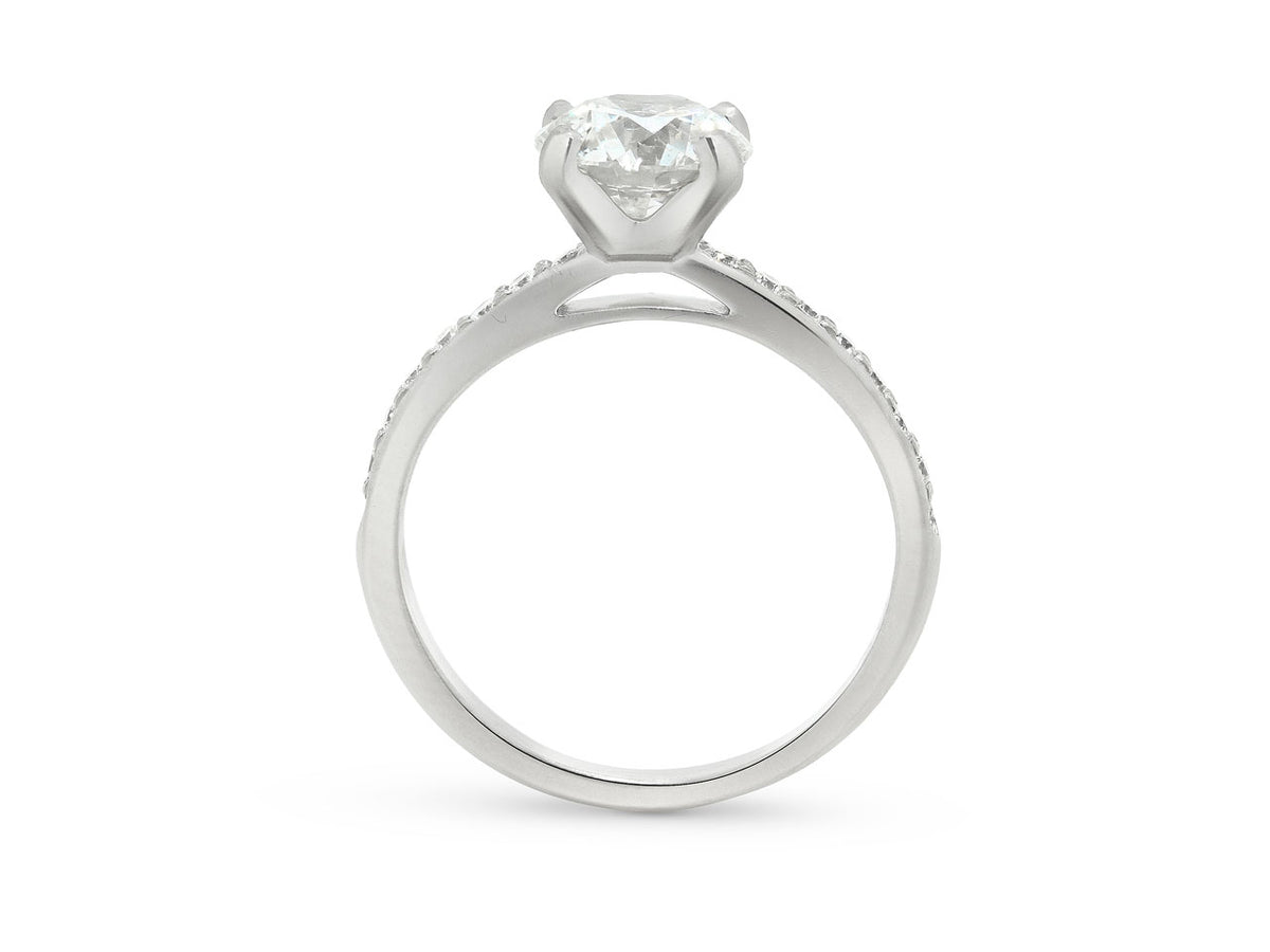 Side view of platinum solitaire ring with diamond pave shoulders