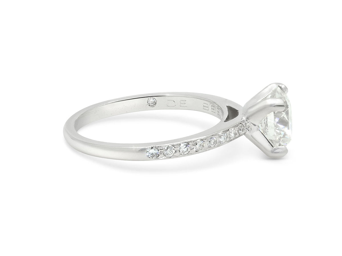 Platinum solitaire ring with pavé diamond shoulders