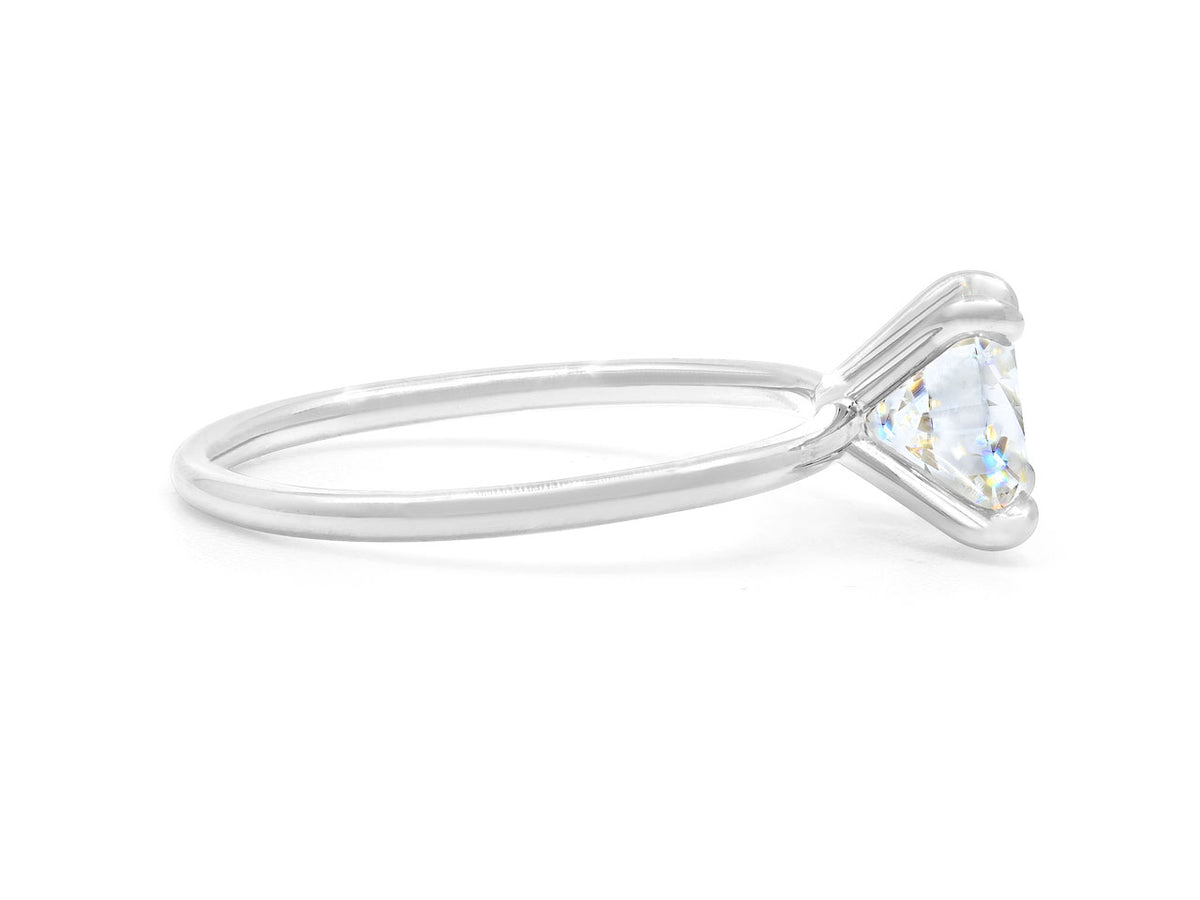 Side view of a platinum ring with round diamond