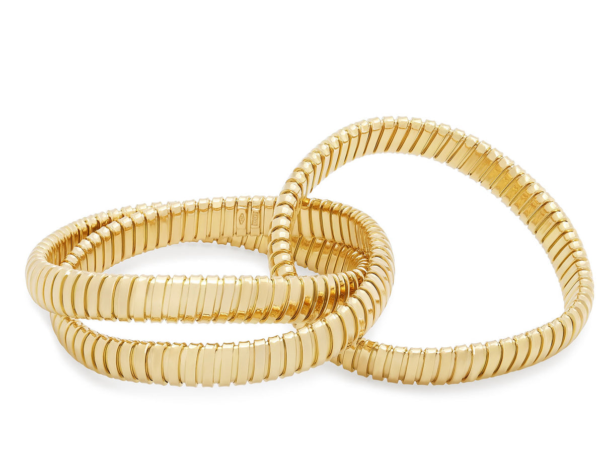 Three interlocking 18K yellow gold tubogas bracelets