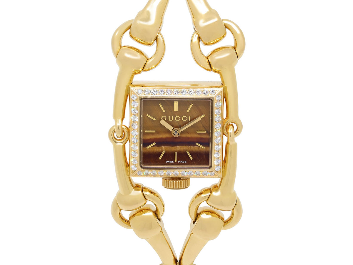 Gucci 18K gold horsebit watch with tiger eye dial