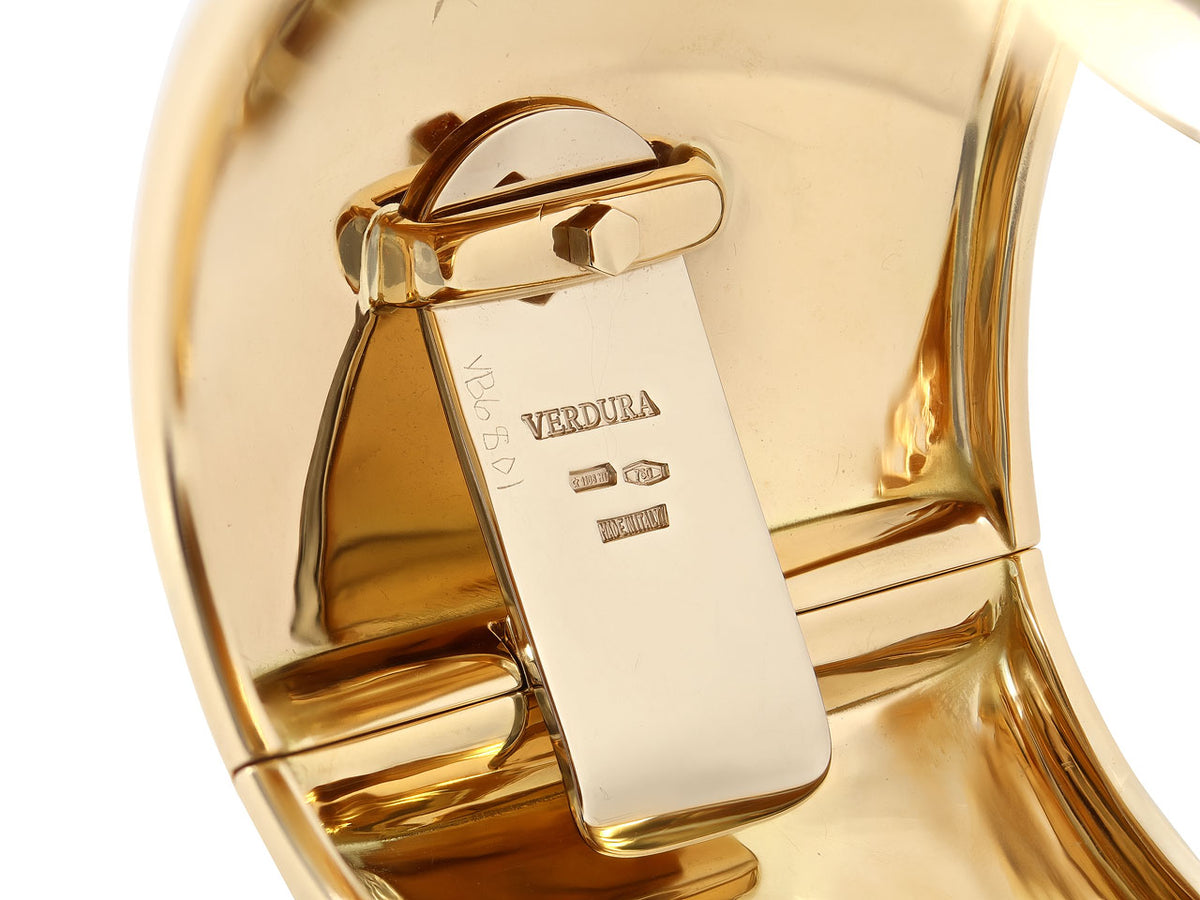 Close view of 18K gold cuff bracelet clasp and hallmarks