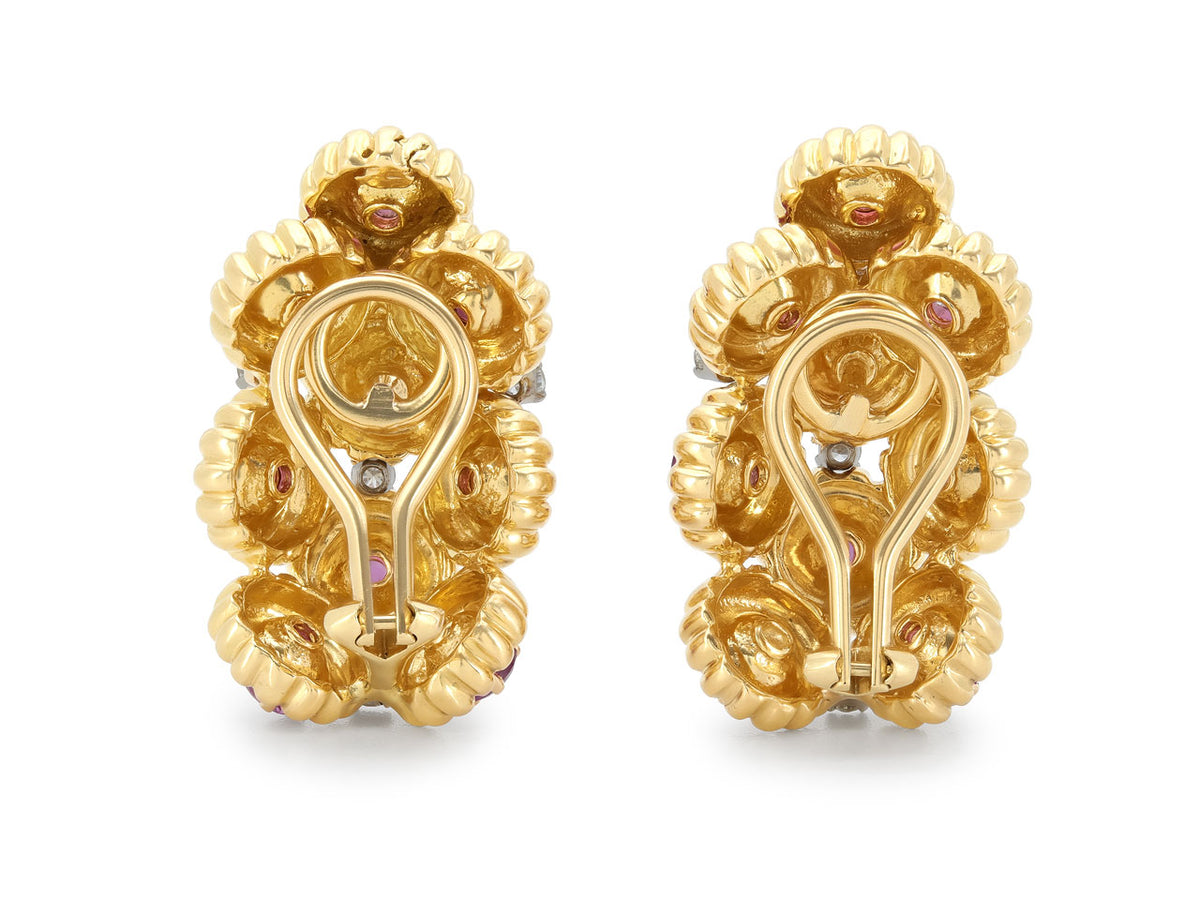 Back view of ornate yellow gold ruby and diamond earrings with omega backs