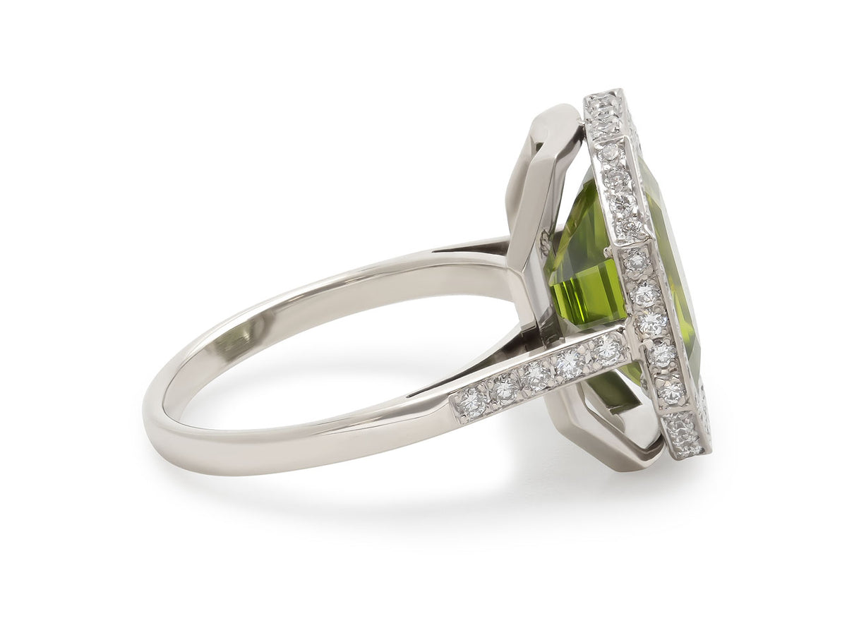 Side view of white gold ring with peridot and diamonds