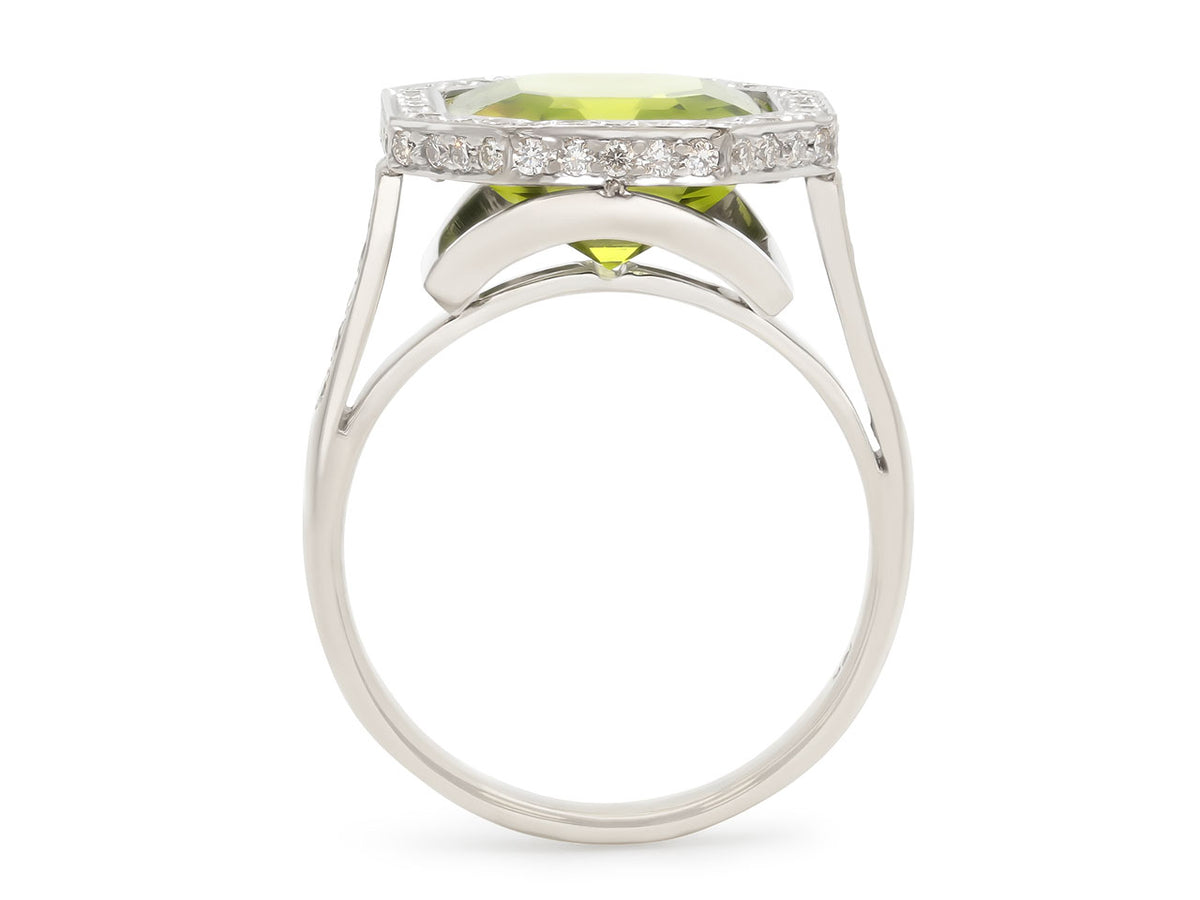Side view of a white gold ring with peridot and diamonds