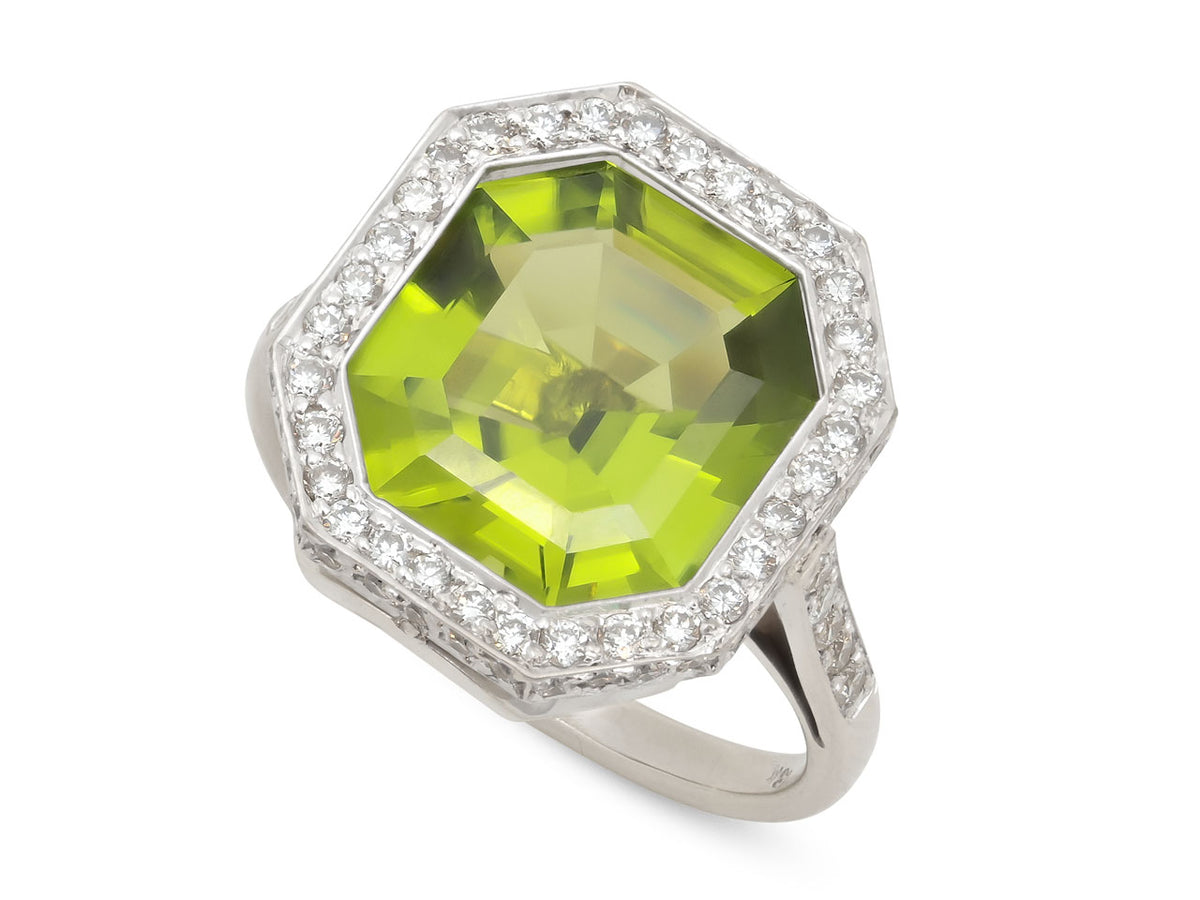 Large step cut peridot ring with double diamond halo in white gold