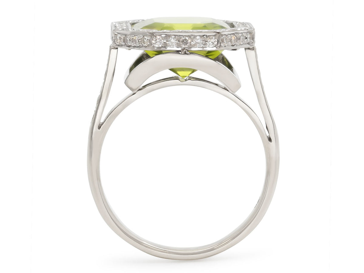 Side view of a peridot and diamond ring in white gold