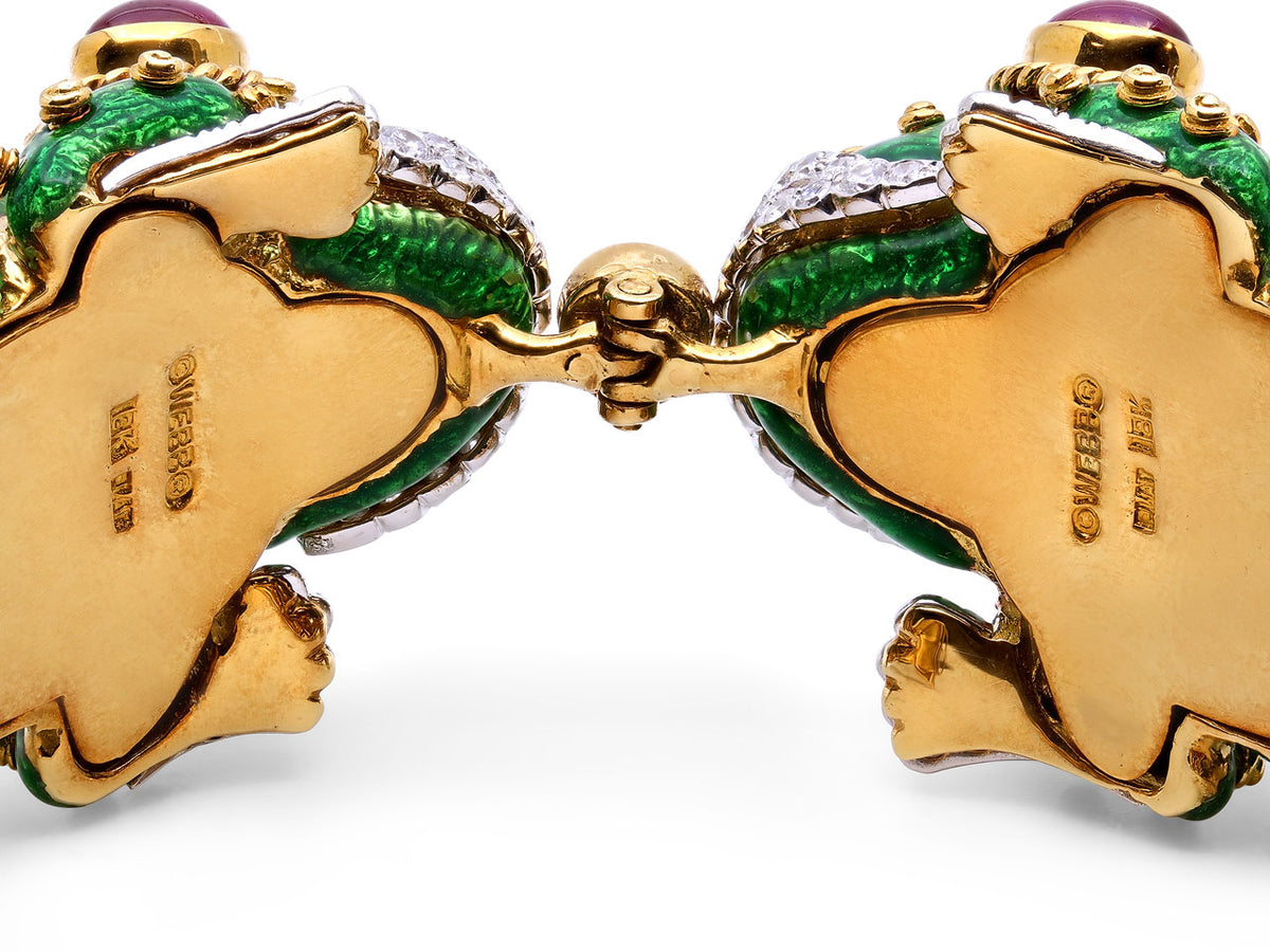 Underside of a hinged gold frog bracelet with green enamel