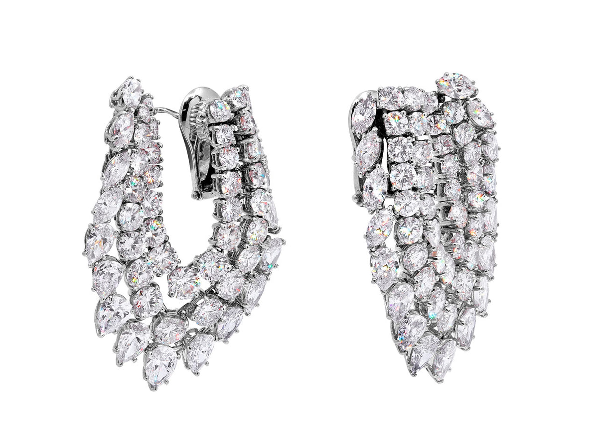 Platinum diamond earrings with elongated flexible hoop design