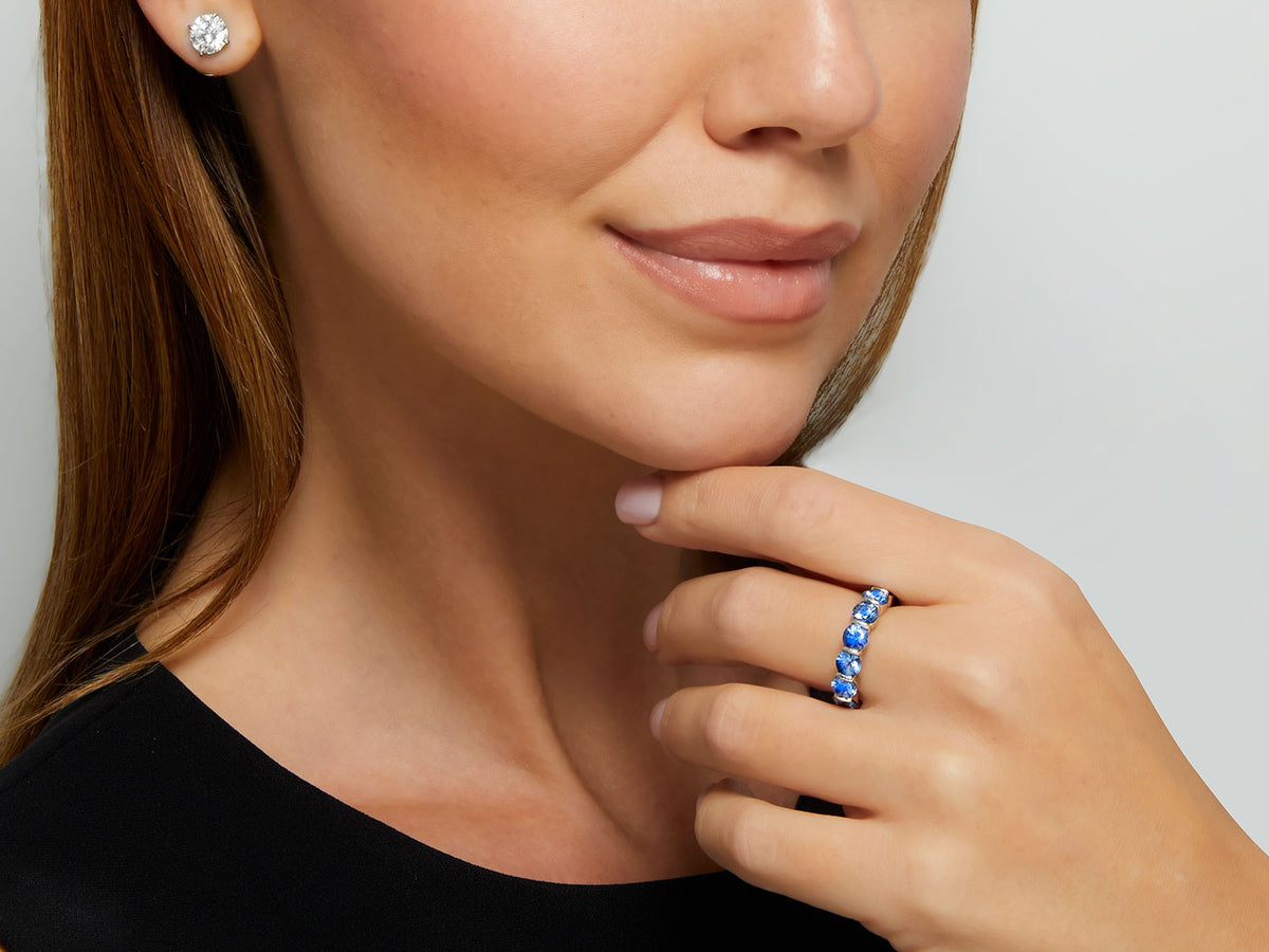 Woman wearing a blue sapphire eternity band