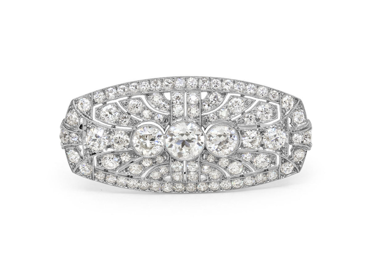 Platinum brooch with three old European cut diamonds and border