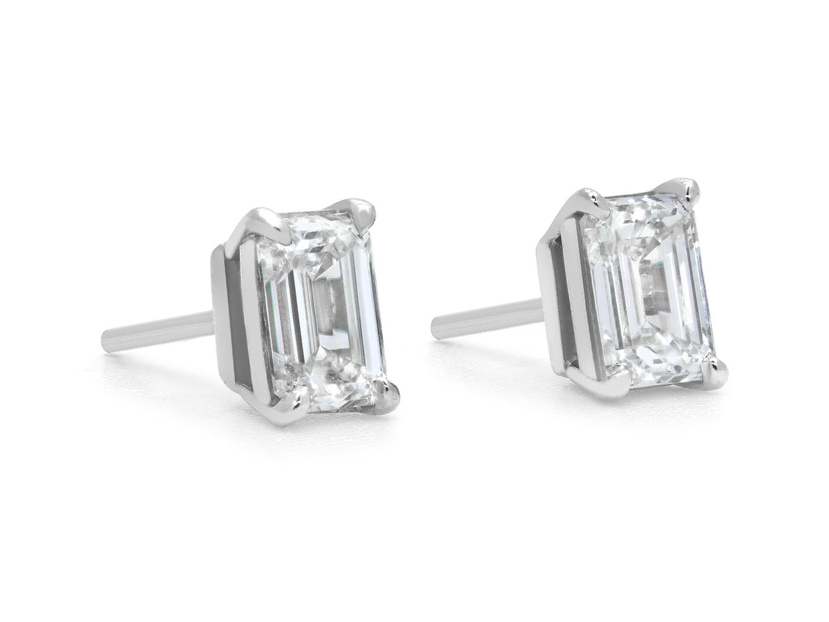 Pair of emerald cut diamond stud earrings in platinum