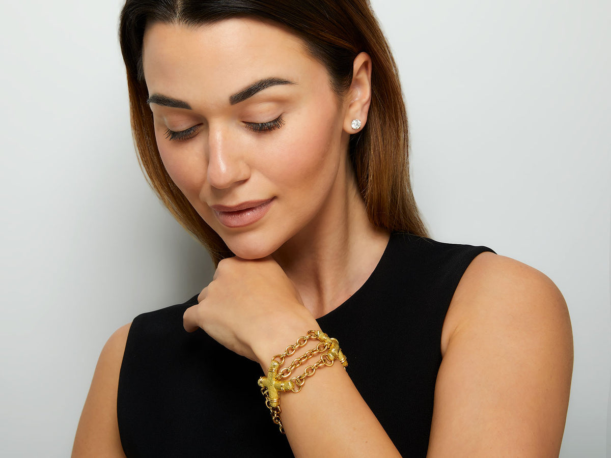Woman wearing a triple strand gold X link bracelet