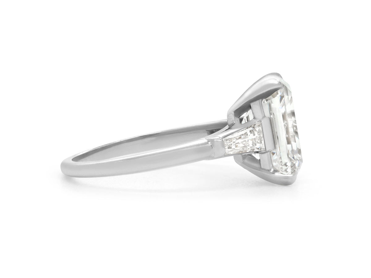 Side view of platinum emerald cut diamond ring
