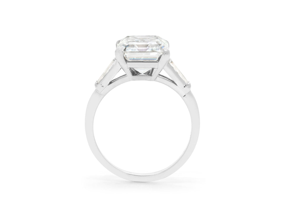 Side view of platinum emerald cut diamond ring with tapered baguettes