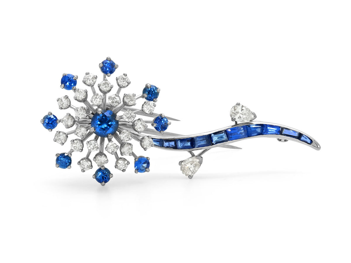 Platinum flower brooch with sapphires and diamond leaves