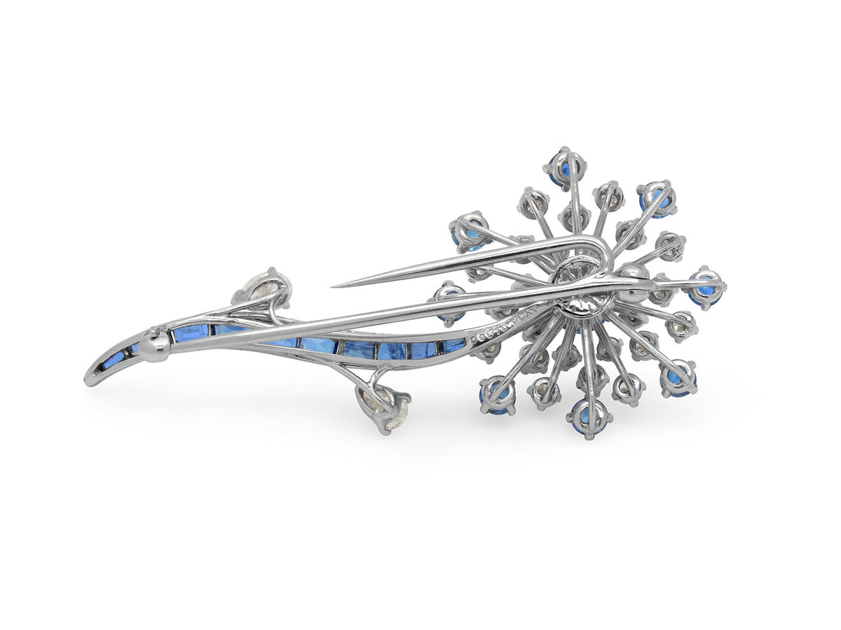 Platinum floral brooch with diamond and sapphire accents