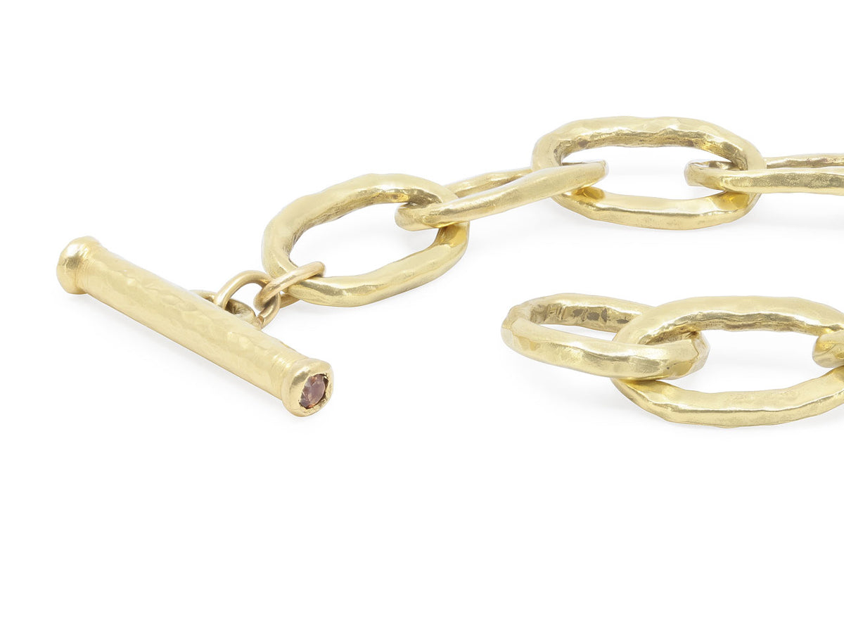 Hand hammered oval link bracelet with gold toggle clasp