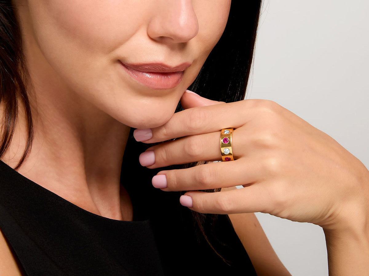 Woman wearing an 18K gold ruby and diamond ring