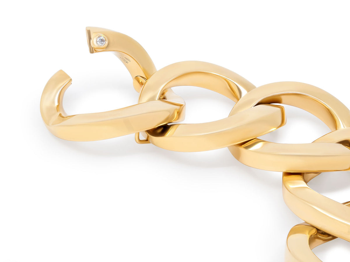 Close-up of large polished 18K yellow gold bracelet links