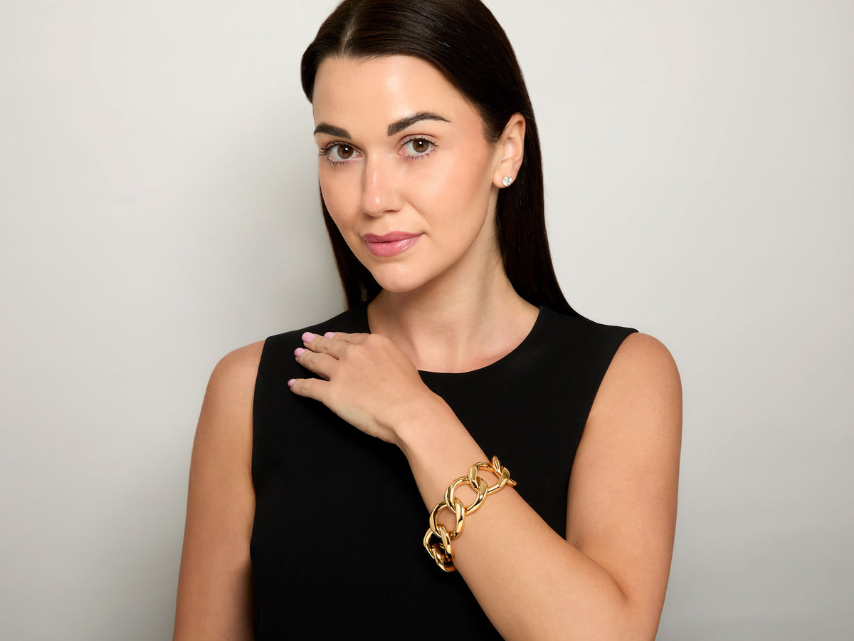 Model wearing an 18K gold curb link bracelet