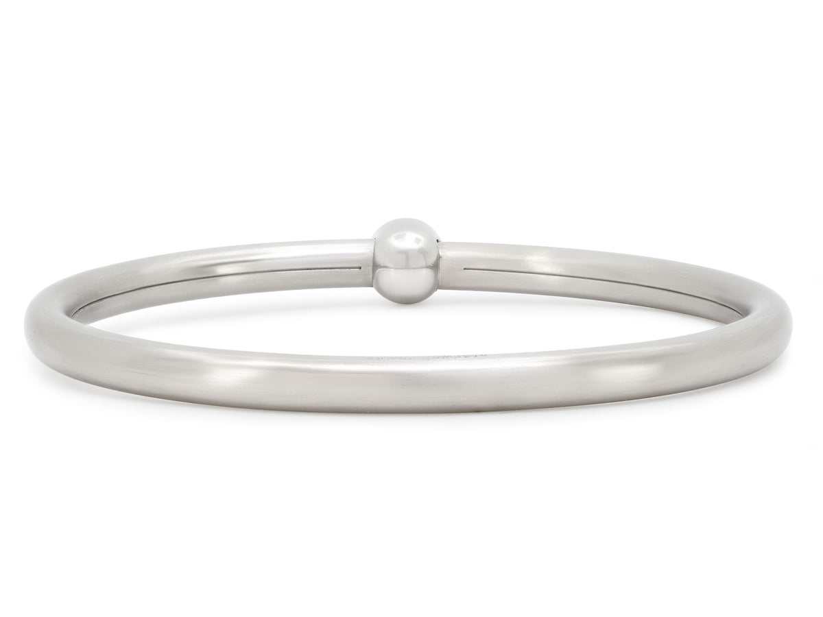 Platinum bangle bracelet with central round diamond