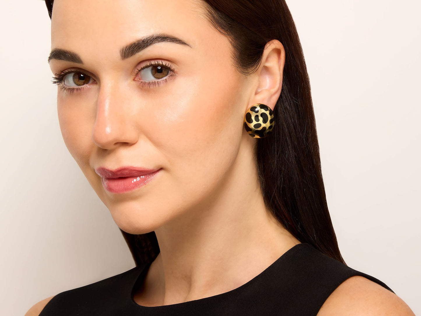 Model wearing Angela Cummings Black Jade Earrings in 18K Gold, oval bombe earrings with black jade spots and polished gold, from Beladora Sold Archives
