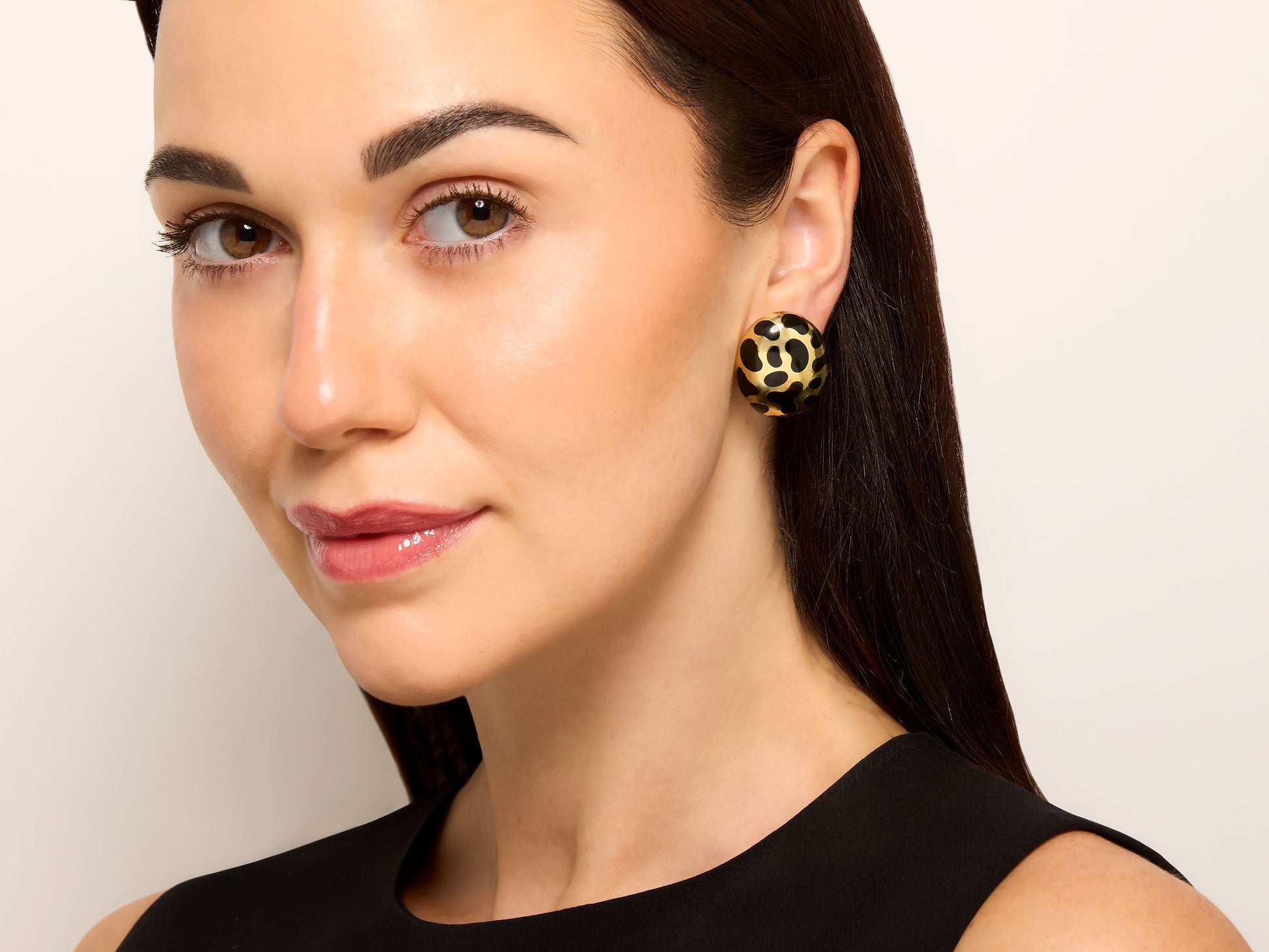 Model wearing Angela Cummings Black Jade Earrings in 18K Gold, oval bombe earrings with black jade spots and polished gold, from Beladora Sold Archives
