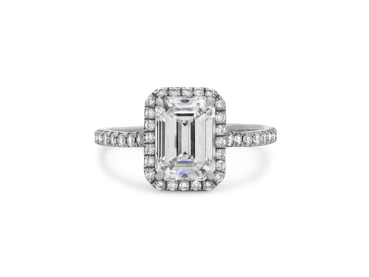 Tiffany & Co. 'Soleste' Emerald-Cut Diamond Ring, 1.54 Carat F/VVS2, in Platinum, shown with diamond halo and pavé shoulders, from Beladora